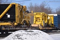 Closeup on the High/Wide load, the frames of a pair of large haul trucks