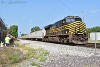 The conductor waves from the cab of NKP 8100 as they thunder past 