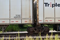A closeup of the bogie and the coupling between trailers